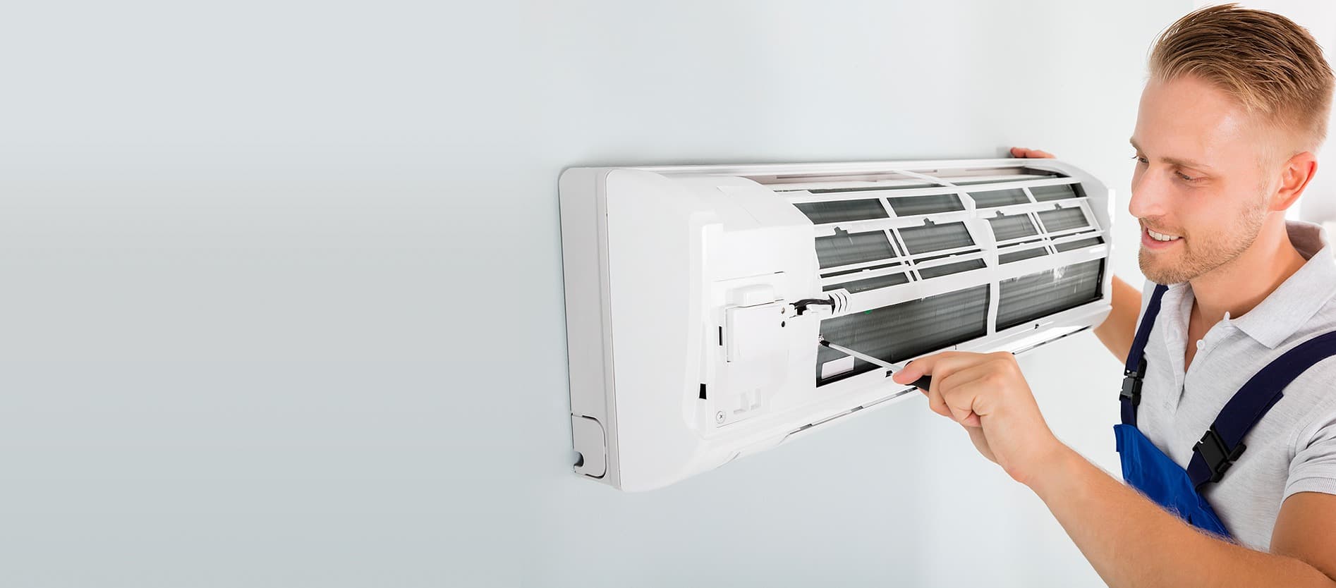 Technician checking an air-conditioning unit.